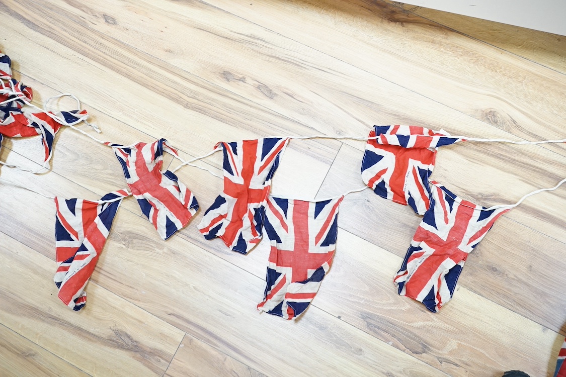 Two early 20th century strands of British patriotic bunting, one comprising 17 flags including the union flag, the British Empire South African flag, Canada flag (1892-1965), Australian Red Ensign, etc., together with a